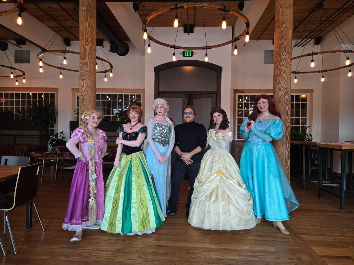 David J Abdoo poses with princesses at the March Princess Brunch